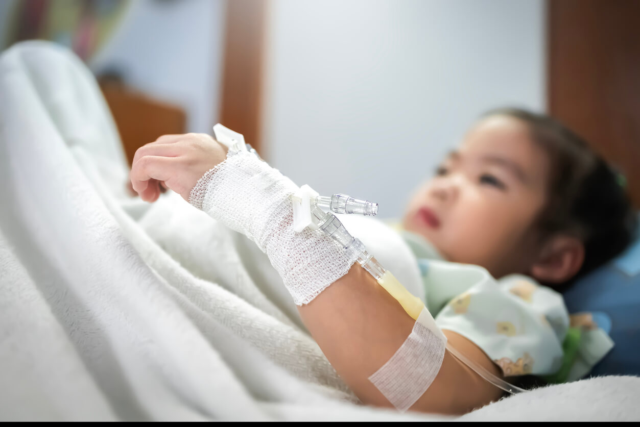Little girl patient in hospital bed.