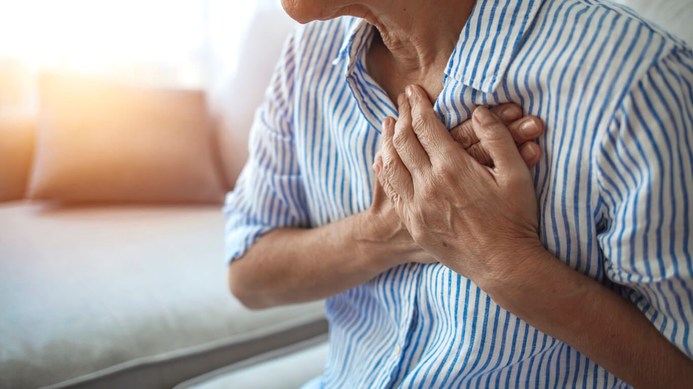 Senior woman feeling pain ache touching chest